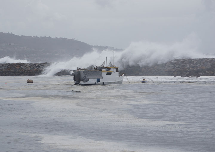 boat-in-harbor-water-cascading-beak-wall