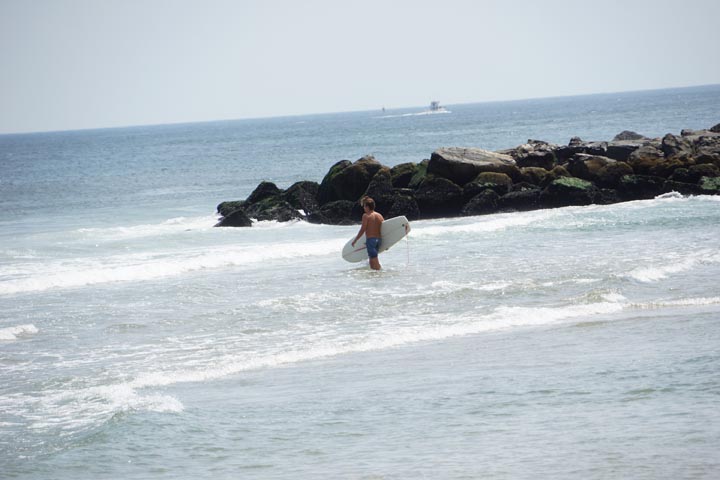 jersey-surfer-by-rocks-ocean-grove