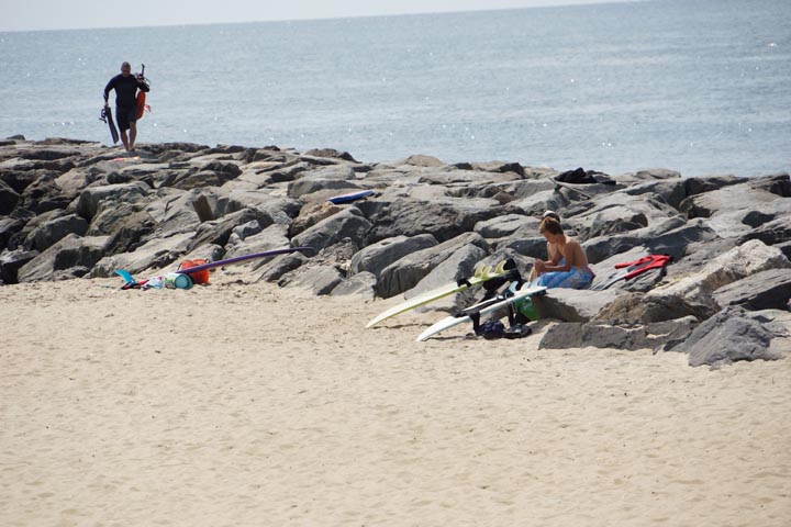 manasquan-surfers-with-boards-rocks