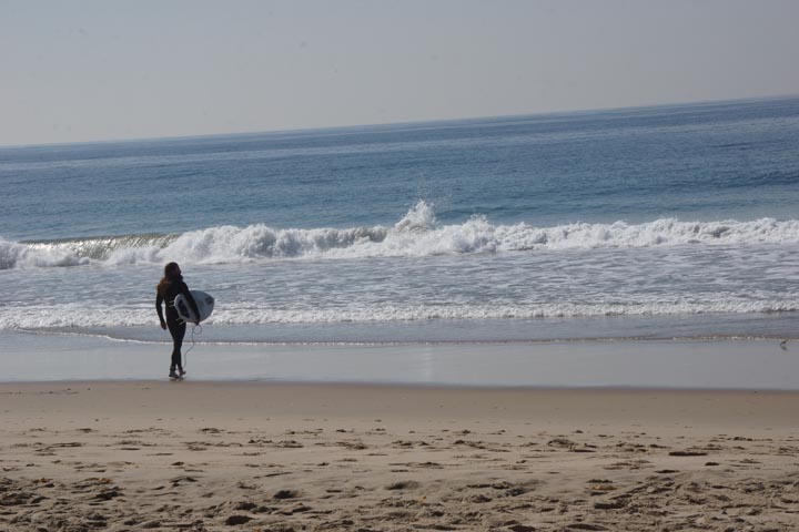 bearded-surfer-walking-toward-waves-hermosa
