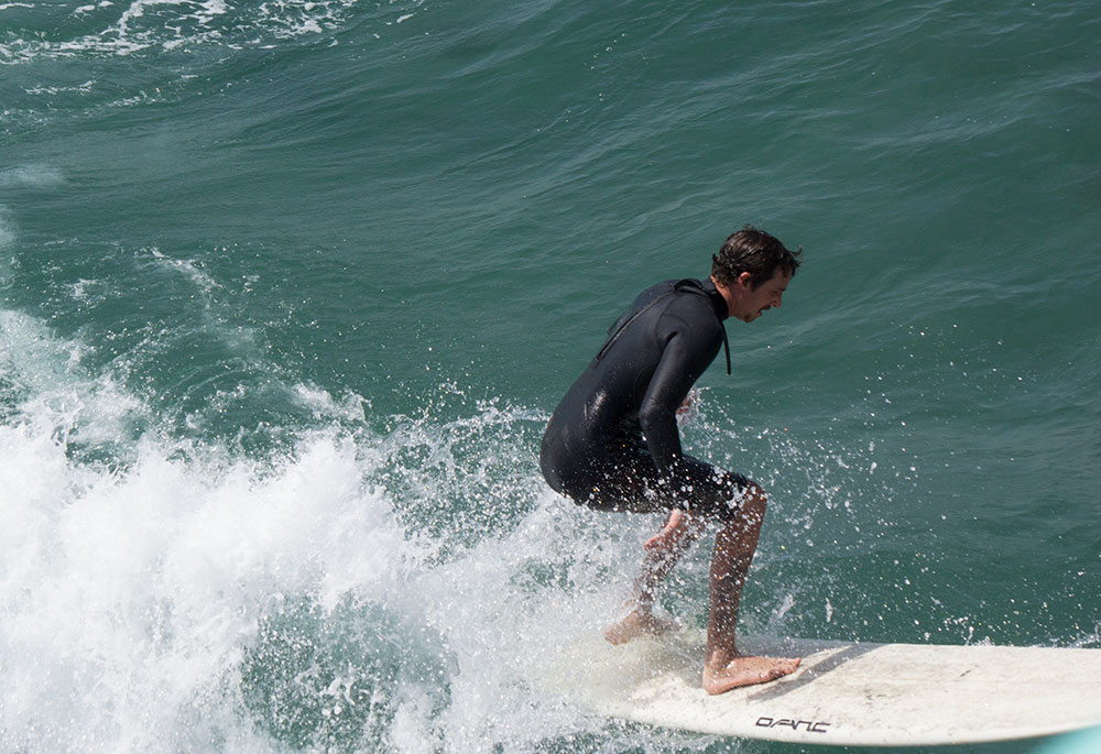 mb-surfer-heading-toward-pier-april