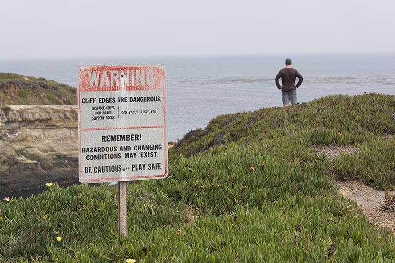 cliff-edge-warning-man-santa-cruz