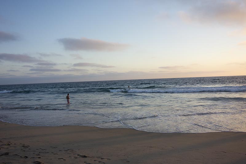 wading-into-water-near-sunset-hermosa-sun-aug