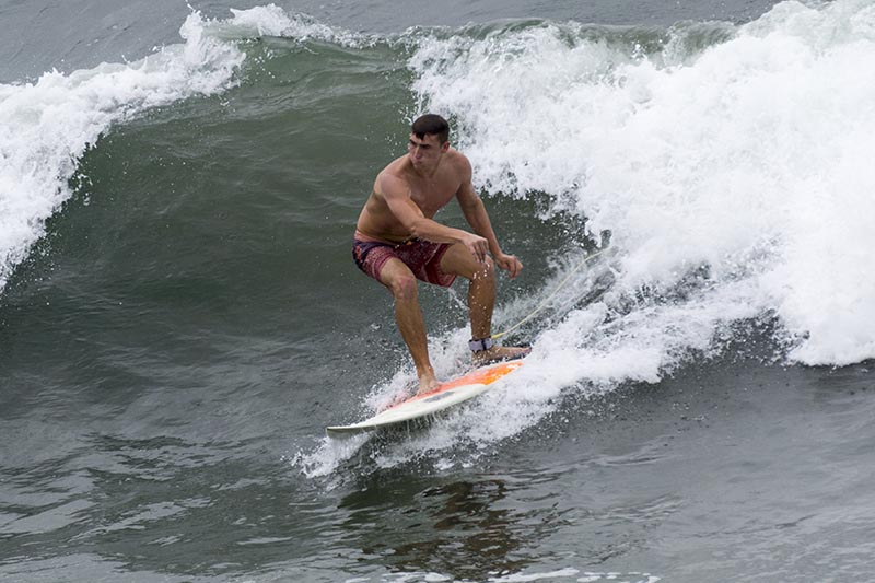 mb-surfer-crouching-cloudy-oct-day