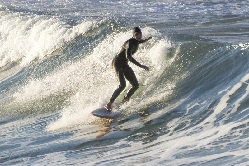 hooded-surfer-hermosa-sunny-jan-morning