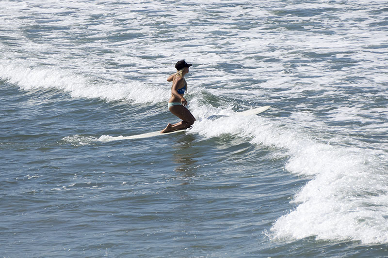 hermosa-surfer-paddling-out-warm-april-sunday
