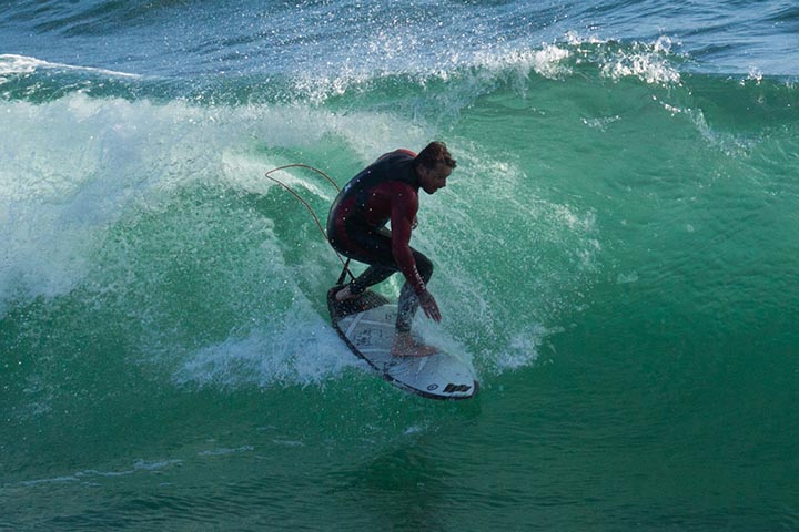 mb-surfer-by-pier-june-sunny