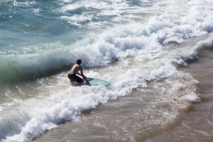skimboarder-by-hermosa-pier-sunday-july